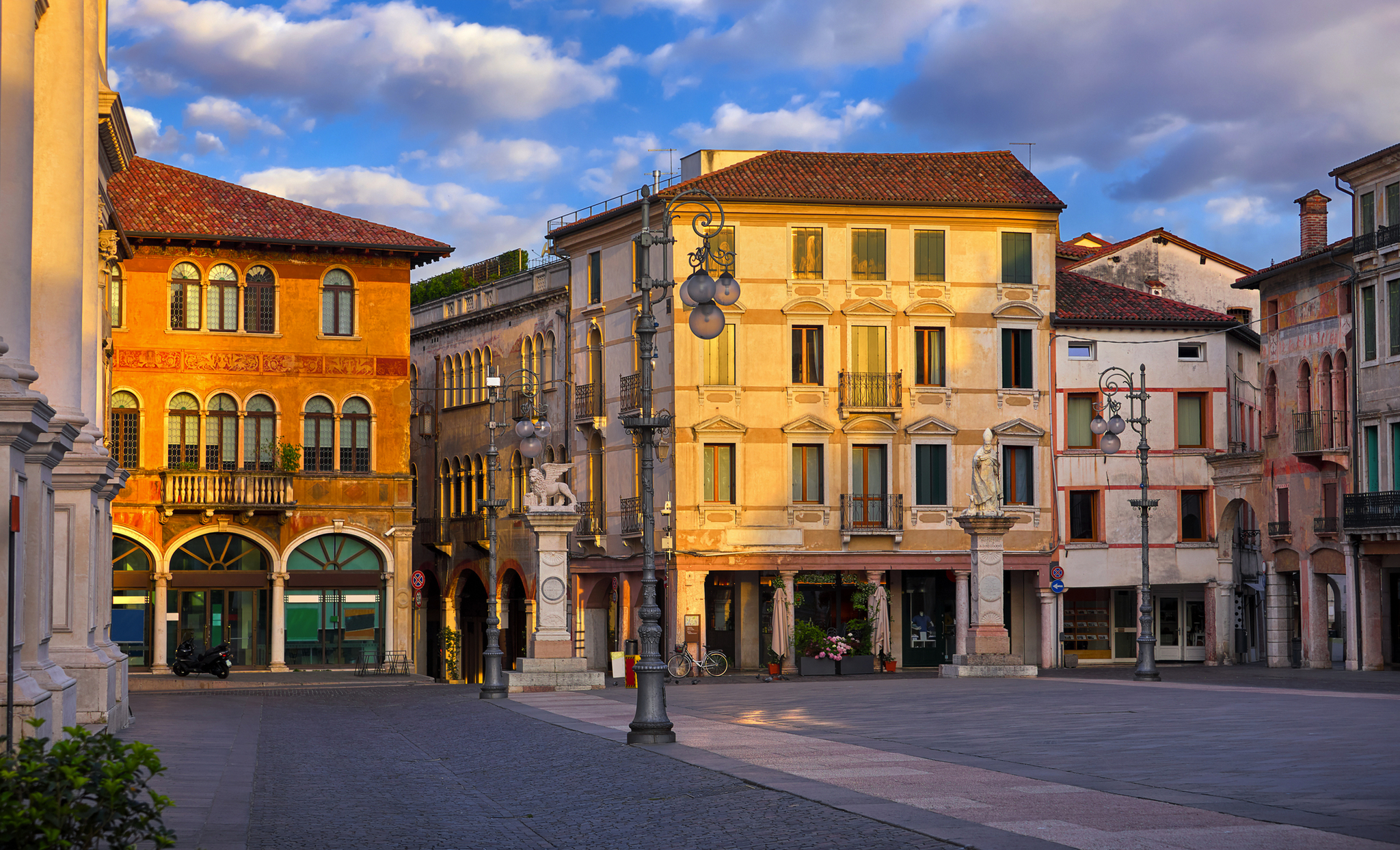 Panoramablick auf Bassano del Grappa mit historischen Gebäuden und einem großen Platz bei Sonnenuntergang in Venetien, Italien.