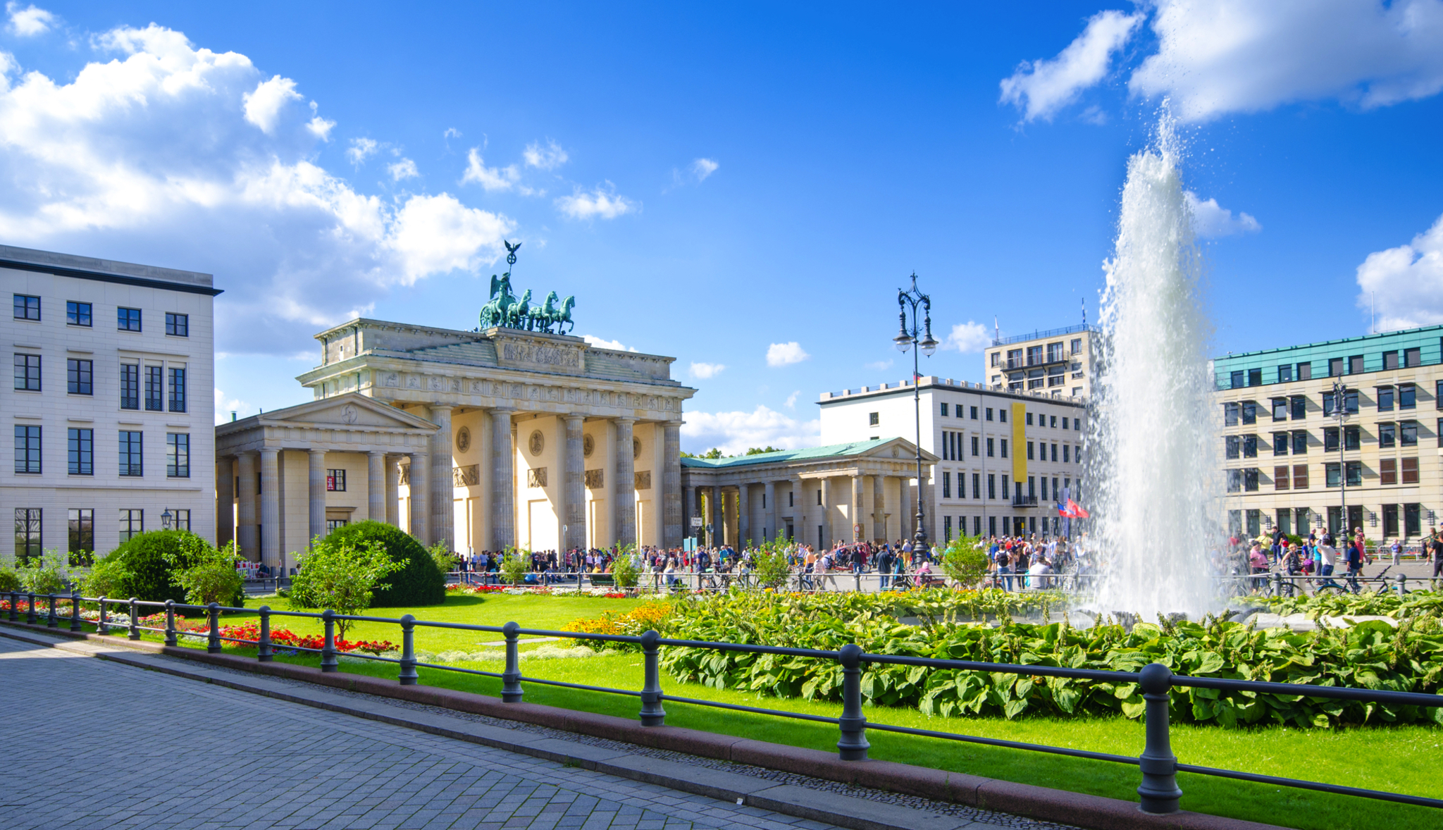 Brandenburger Tor in Berlin Brandenburger Tor in Berlin mit Springbrunnen und blauen Himmel.