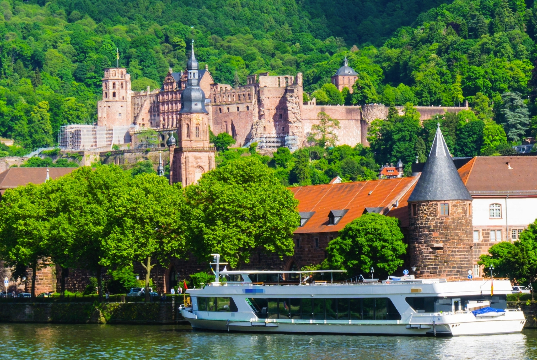Schiff auf dem Fluss Neckar in Heidelberg, im Hintergrund die Heidelberger Altstadt mit dem bekannten Schloss.