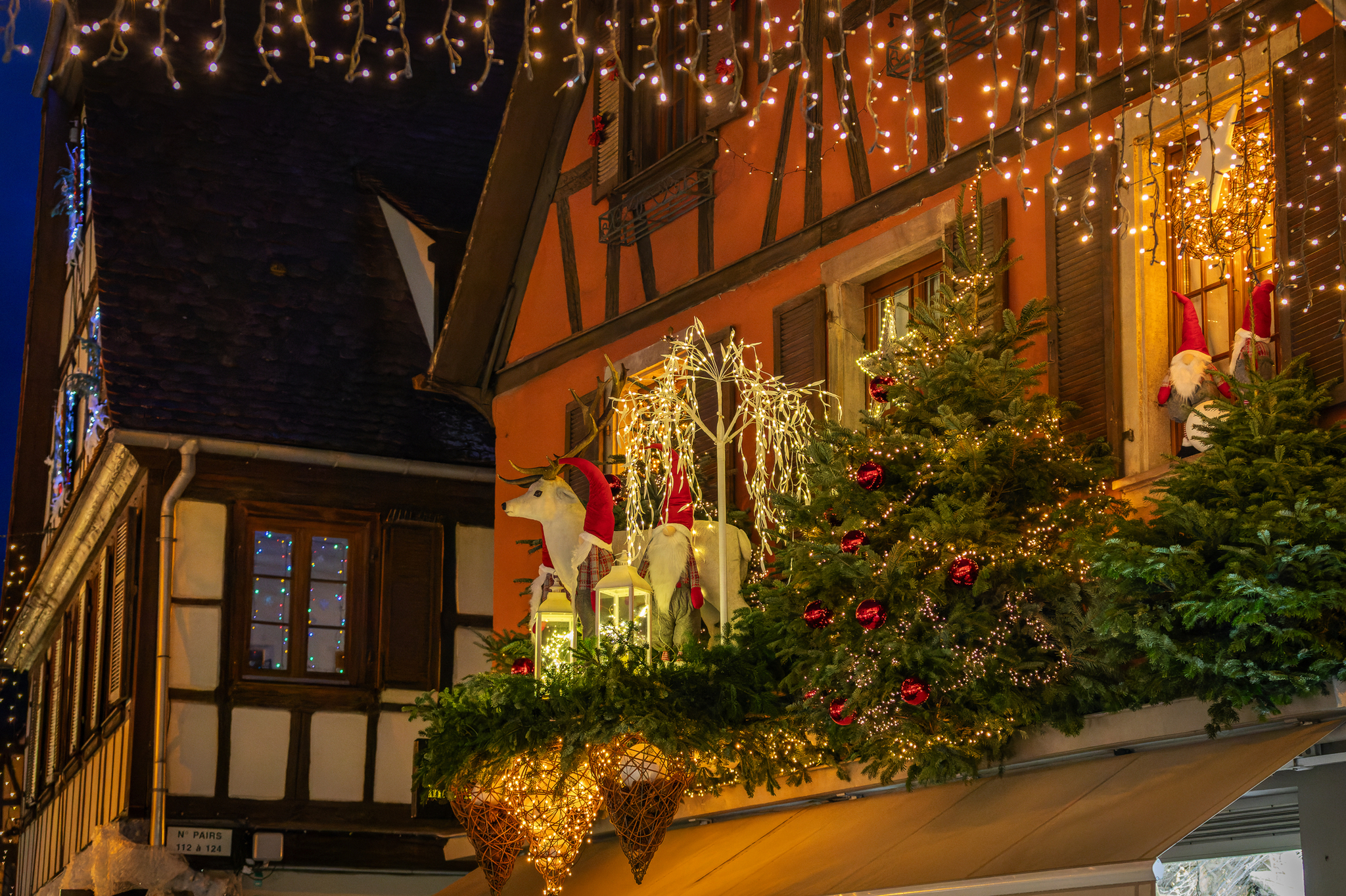 Weihnachtlich geschmücktes Fachwerkhaus mit Lichtern und Weihnachtsdekorationen.