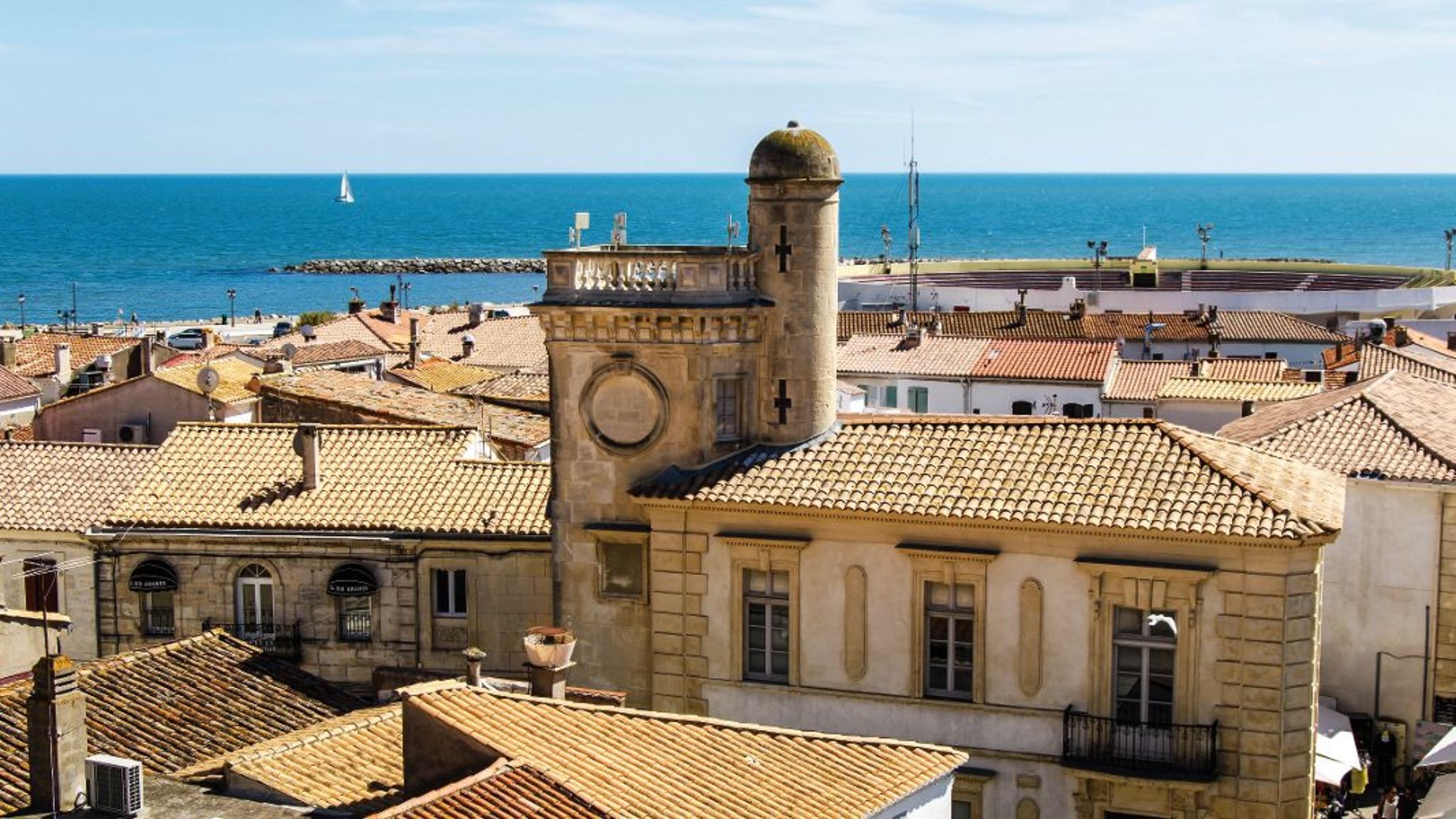 Stadtansicht mit alten Gebäuden und Meer im Hintergrund