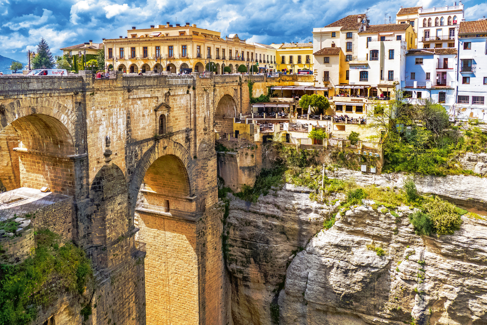 Steinbrücke in Ronda, Spanien, über einer tiefen Schlucht mit Häusern im Hintergrund