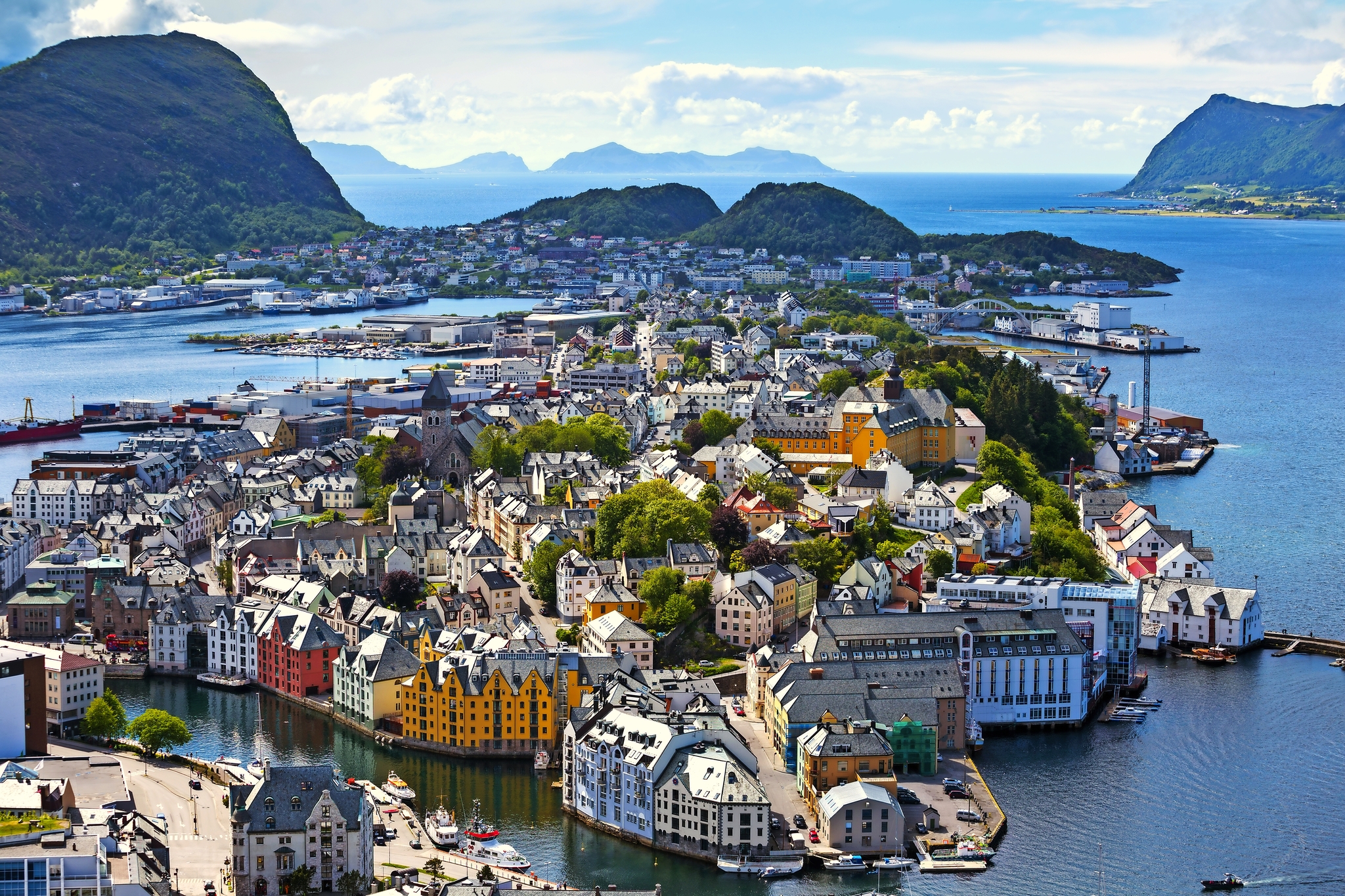 Panorama der Stadt Ålesund in Norwegen mit bunten Häusern und Wasser im Hintergrund.